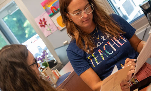 Two teachers work together.